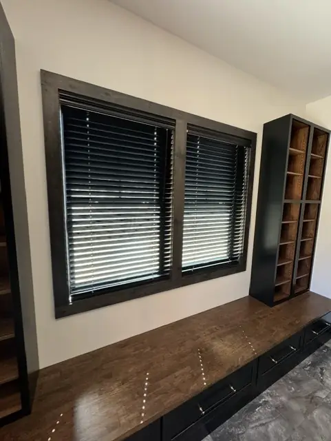 Dark wood blinds over a built-in window bench