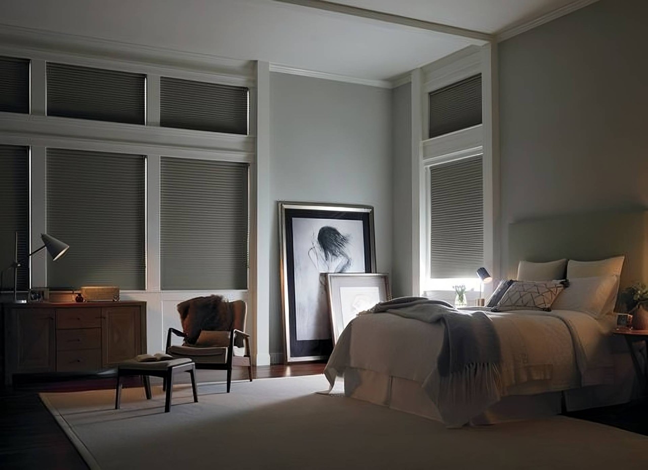 Warm and comfortable bedroom outfitted with Hunter Douglas Duette® Cellular Shades near Windham, NH