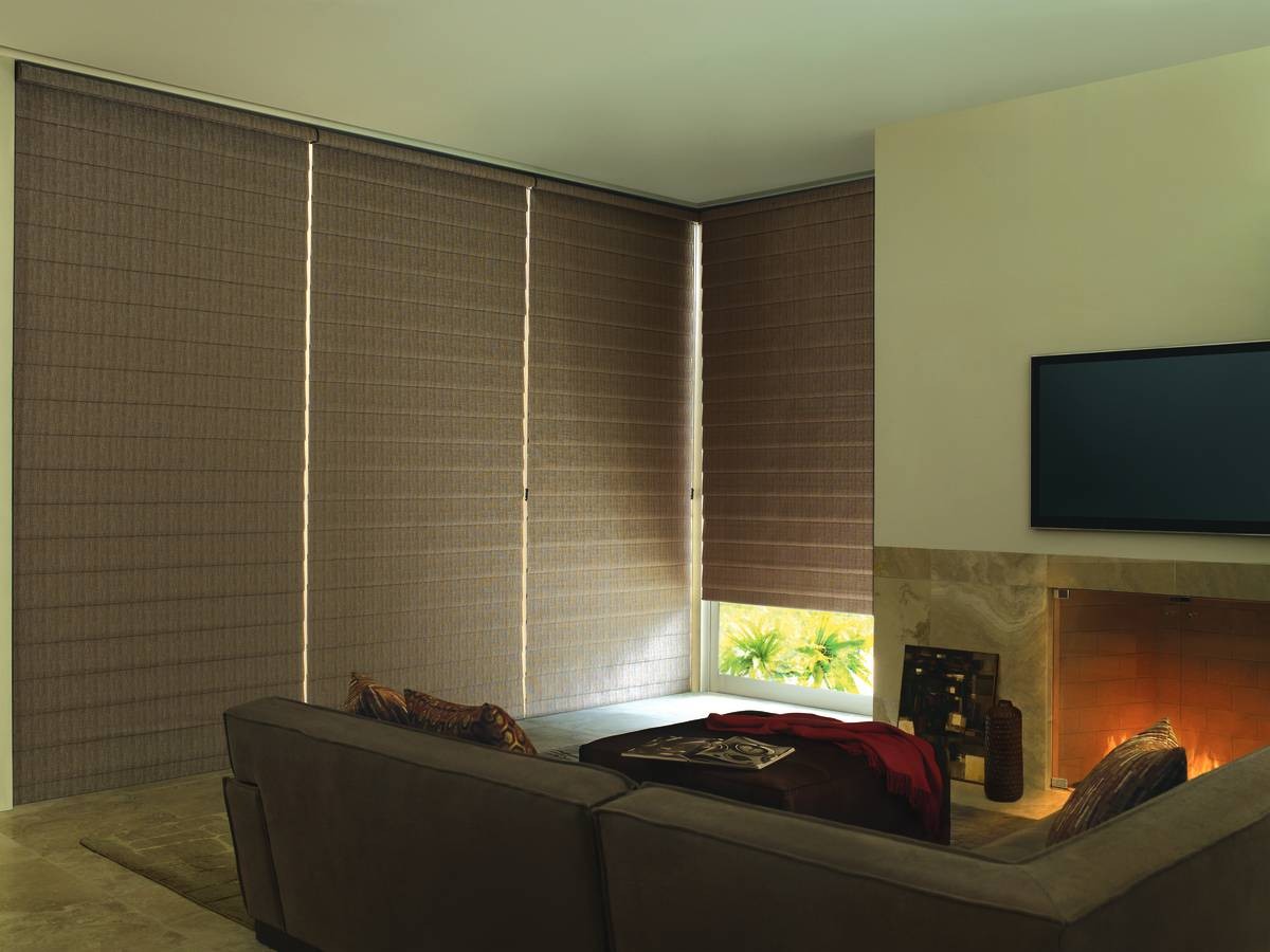 Hunter Douglas Alustra® Woven Textures® Roman Shades drawn over living room windows near Windham, New Hampshire